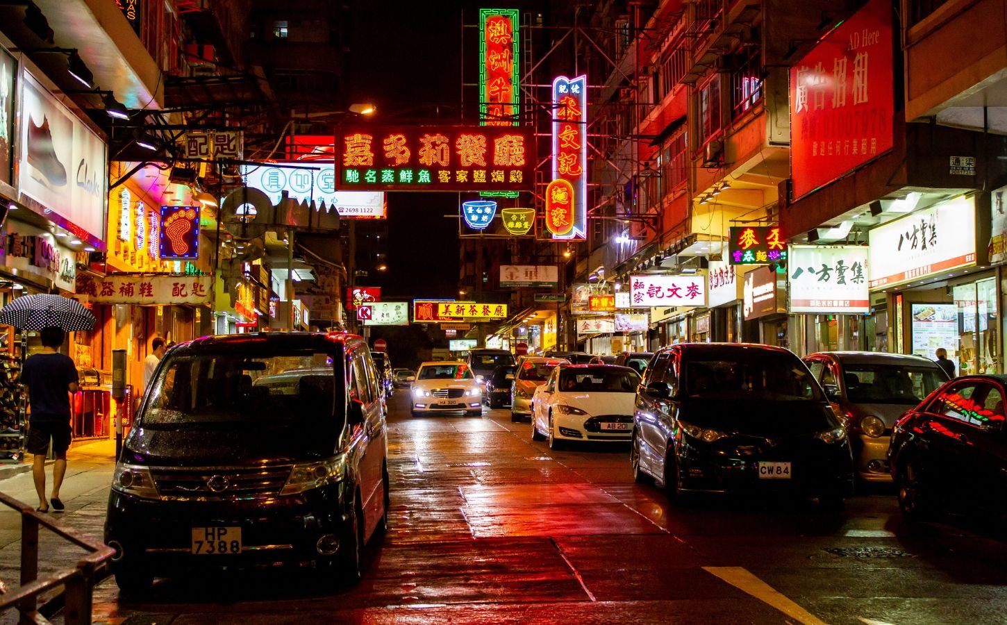 A brightly-lit Hong Kong street at night