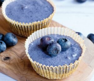 a picture of two mini blueberry cheesecakes with blueberries for decoration