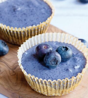 a picture of two mini blueberry cheesecakes with blueberries for decoration