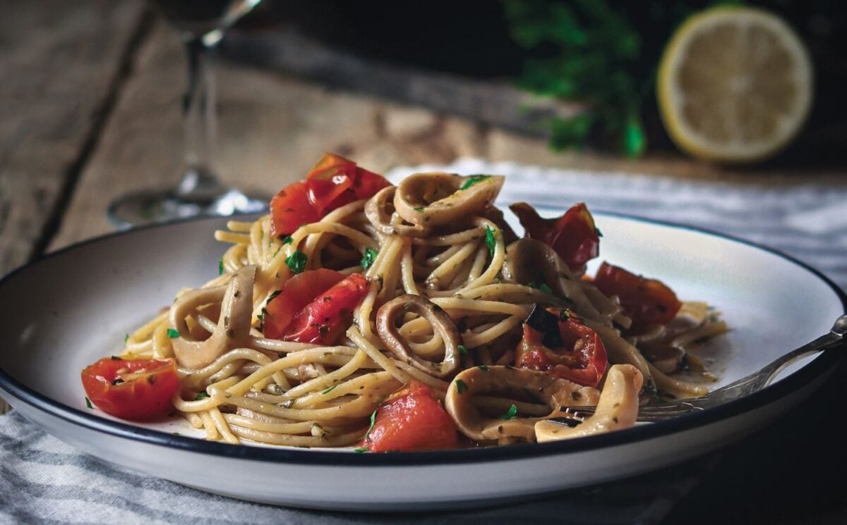 a plate of vegan mushroom calamari spaghetti made with king oyster mushrooms