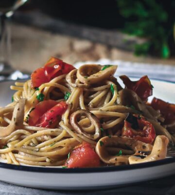a plate of vegan mushroom calamari spaghetti made with king oyster mushrooms