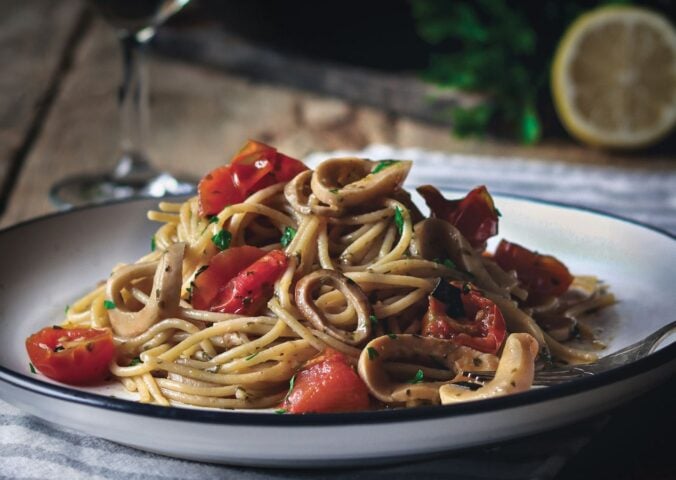 a plate of vegan mushroom calamari spaghetti made with king oyster mushrooms