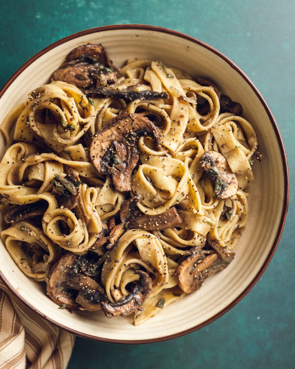 A plate of mushroom and sage pasta cooked to a dairy-free and vegan recipe