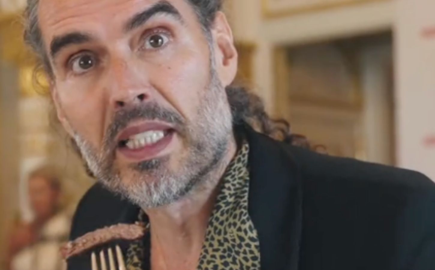 Former vegan Russell Brand eating a steak