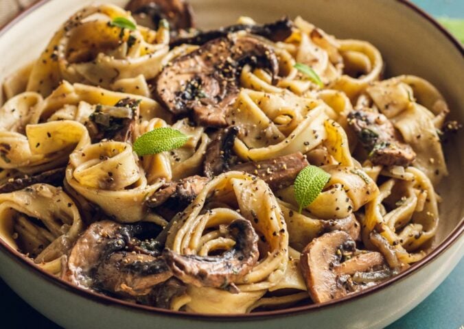 A plate of mushroom and sage pasta cooked to a dairy-free and vegan recipe