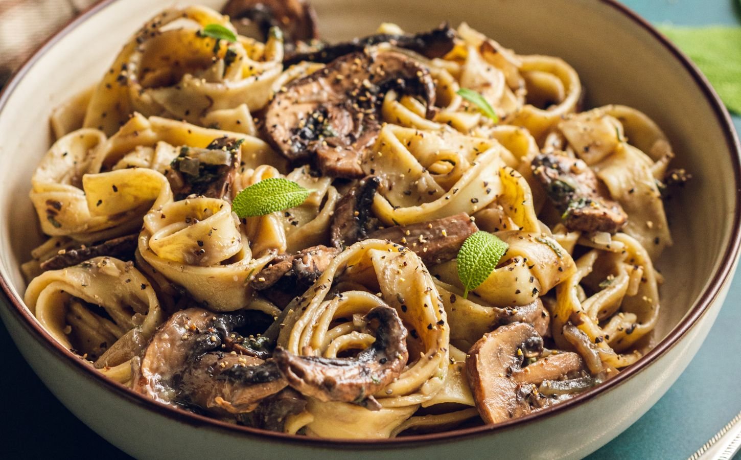 A plate of mushroom and sage pasta cooked to a dairy-free and vegan recipe