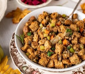 a bowl of vegan savory stove top stuffing with mushrooms, lentils, and bread cubes