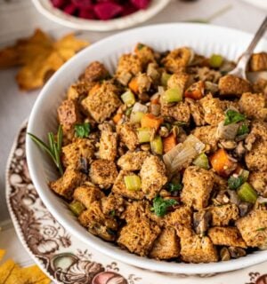 a bowl of vegan savory stove top stuffing with mushrooms, lentils, and bread cubes