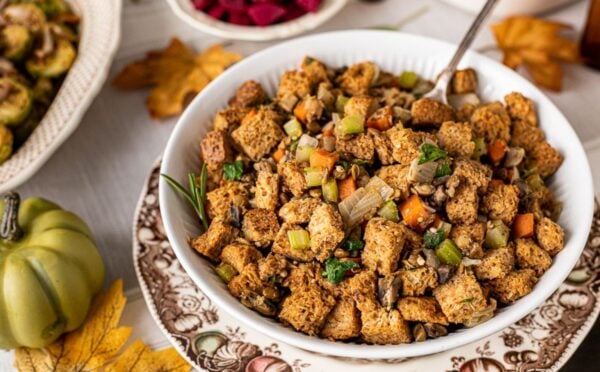 a bowl of vegan savory stove top stuffing with mushrooms, lentils, and bread cubes