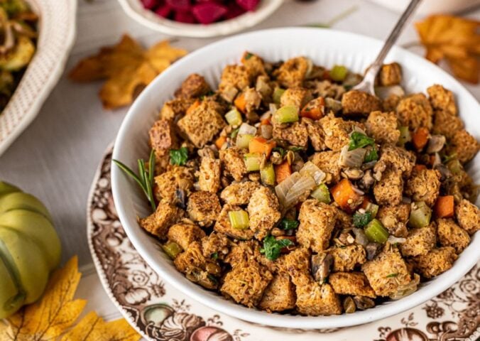 a bowl of vegan savory stove top stuffing with mushrooms, lentils, and bread cubes