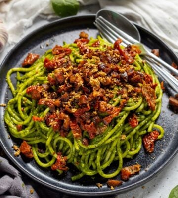 a bowl of seasonal super green spaghetti with chestnuts and sun-dried tomatoes