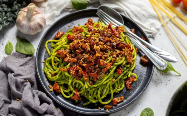 a bowl of seasonal super green spaghetti with chestnuts and sun-dried tomatoes