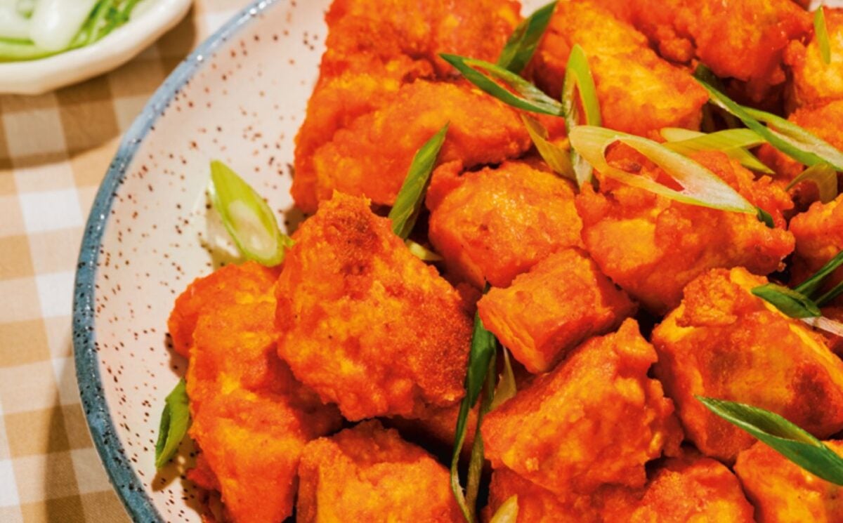 a close up of a bowl of spicy tofu nuggets with tahini ranch