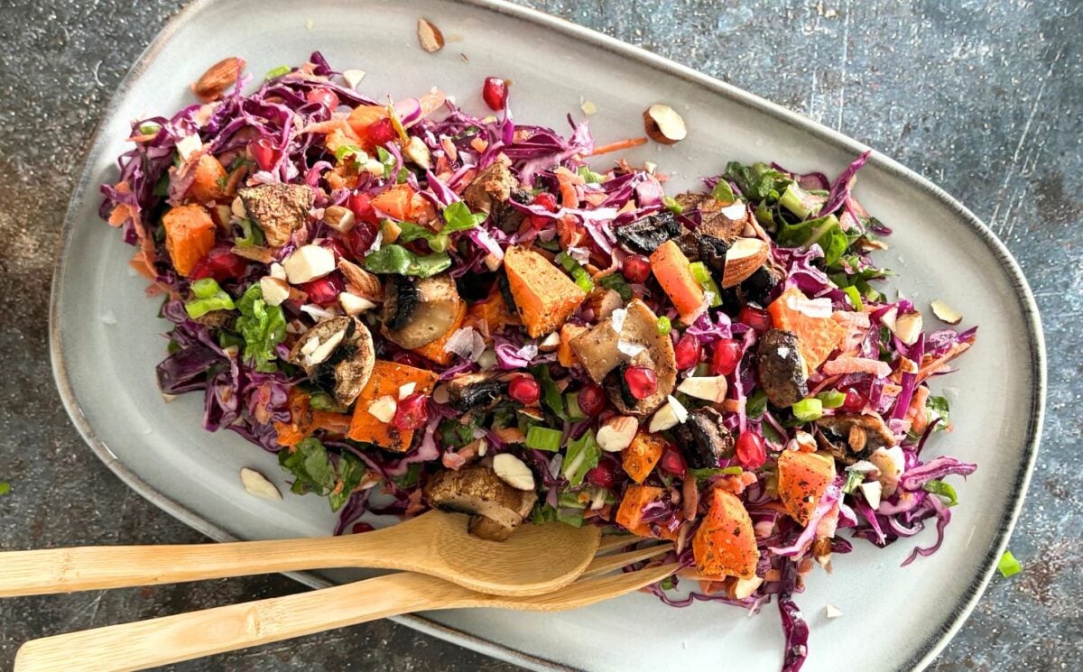 A sweet potato, mushroom, and tahini salad on a plate