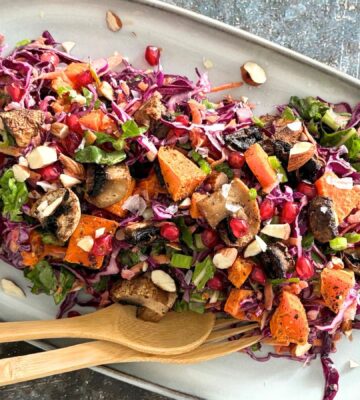 A sweet potato, mushroom, and tahini salad on a plate