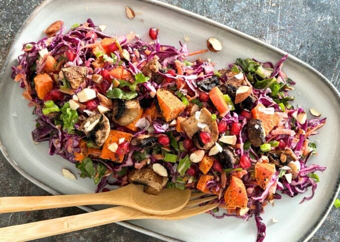 A sweet potato, mushroom, and tahini salad on a plate