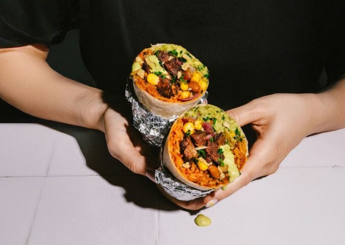 Photo shows someone holding the new Beyond Meat x Tortilla Beyond Steak Chimichurri burrito