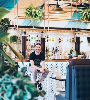 Earthling ED sitting in his London vegan restaurant Unity Diner