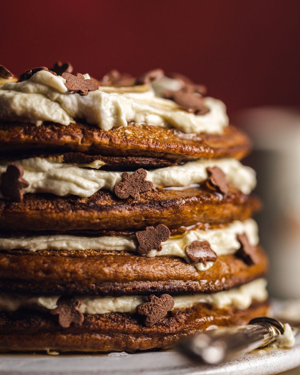 a stack pf vegan gingerbread pancakes with coconut yogurt layers