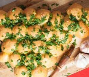 a Christmas tree garlic bread sharer topped with parsley, part of vegan recipes to serve at your Christmas party