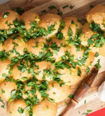 a Christmas tree garlic bread sharer topped with parsley, part of vegan recipes to serve at your Christmas party