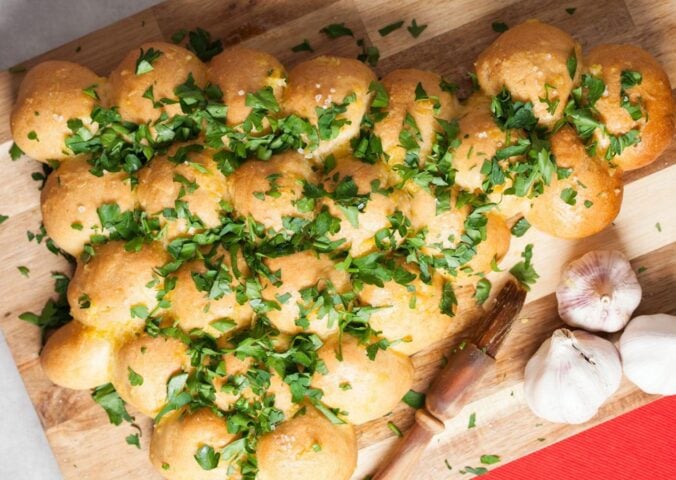 a Christmas tree garlic bread sharer topped with parsley, part of vegan recipes to serve at your Christmas party