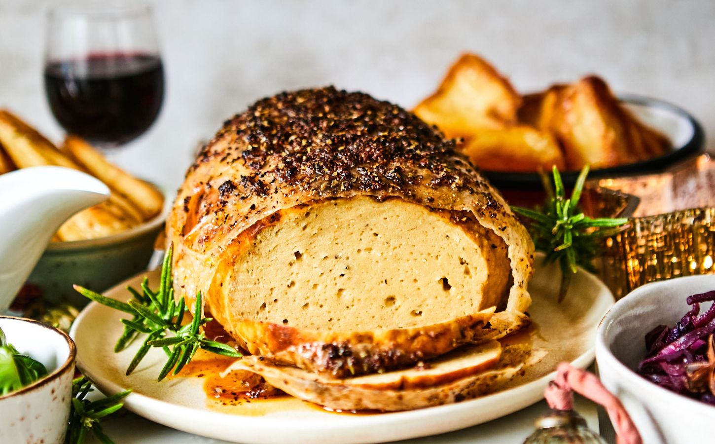 A vegan turkey roast on a plate at a Christmas dinner