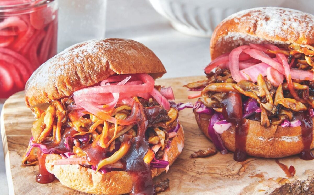 two BBQ pulled mushroom sandwiches with homemade creamy coleslaw and pickled onions