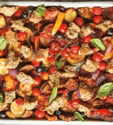 an Italian veggie sheet bake with eggplant, zucchini, olives, tomato, and bread