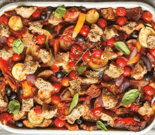 an Italian veggie sheet bake with eggplant, zucchini, olives, tomato, and bread