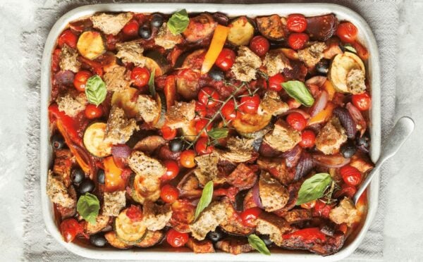 an Italian veggie sheet bake with eggplant, zucchini, olives, tomato, and bread