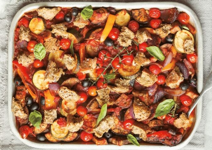 an Italian veggie sheet bake with eggplant, zucchini, olives, tomato, and bread