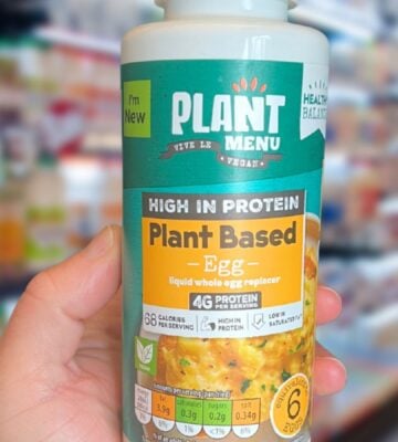 A hand holding up the new Aldi vegan liquid egg, one of Aldi's new veganuary launches, in a supermarket
