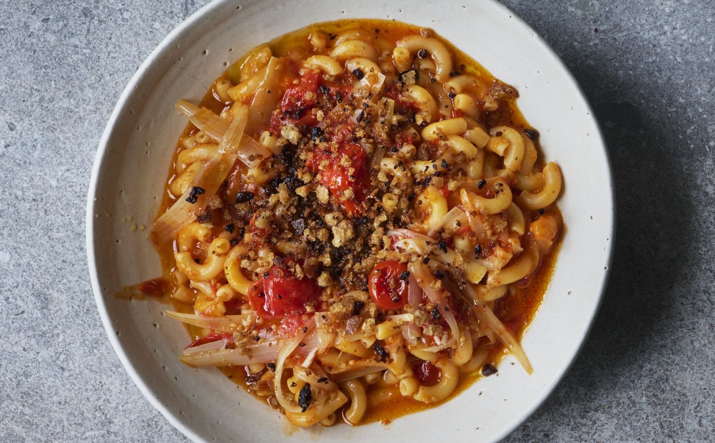 a bowl of balsamic tomato macaroni with olive pangrattata