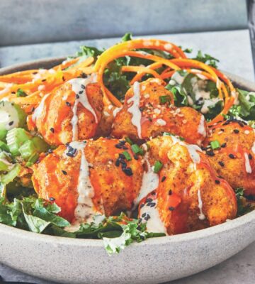 one of the buffalo cauliflower wings bowls with kale, hemp hearts, and sesame seeds