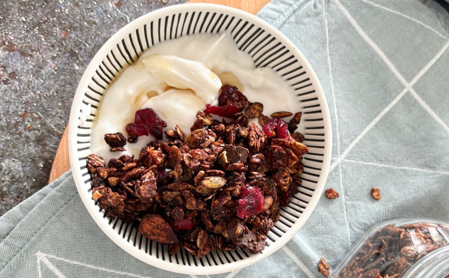 A bowl of vegan chocolate granola with dairy-free yogurt