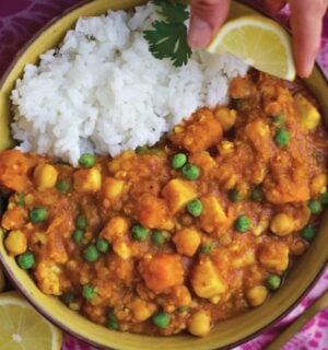 a bowl of curry spiced red lentil stew with rice