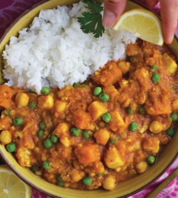 a bowl of curry spiced red lentil stew with rice