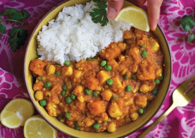 a bowl of curry spiced red lentil stew with rice