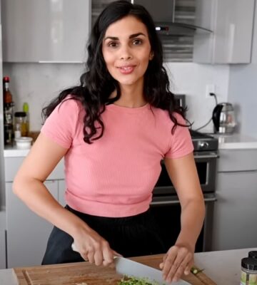 A still of vegan chef Nisha Vora (RainbowPlantLife) from a YouTube video showing her cooking her vegan red lentil recipe