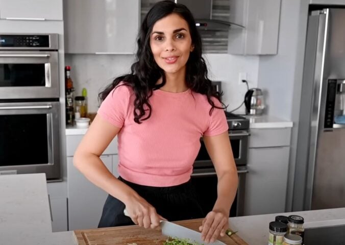 A still of vegan chef Nisha Vora (RainbowPlantLife) from a YouTube video showing her cooking her vegan red lentil recipe