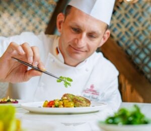 A chef preparing an Emirates vegan menu item