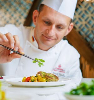 A chef preparing an Emirates vegan menu item