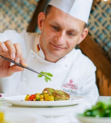 A chef preparing an Emirates vegan menu item