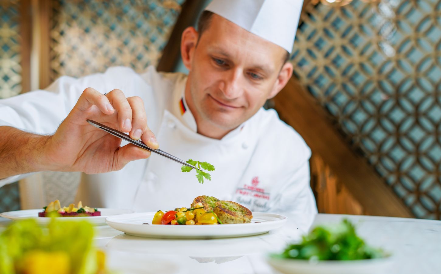 A chef preparing an Emirates vegan menu item