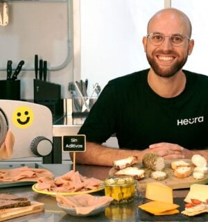 Heura founder Marc Coloma sitting with some of the plant-based meat company's products and equipment