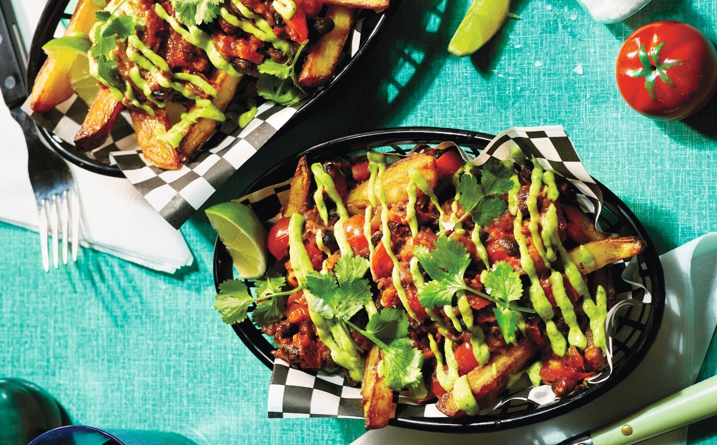 Two baskets of pulled aubergine and black bean loaded fries