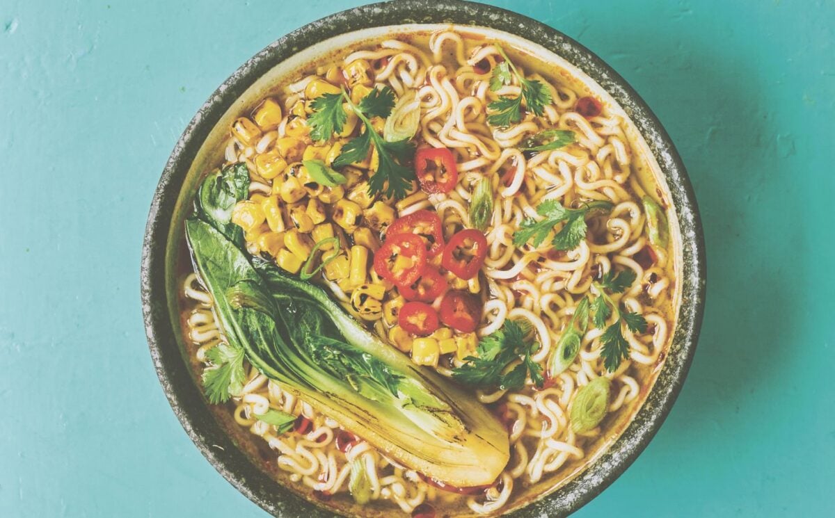 a picture of a pimped instant ramen bowl with sweetcorn, bak choy, and chili for vegan lunches to make when working from home