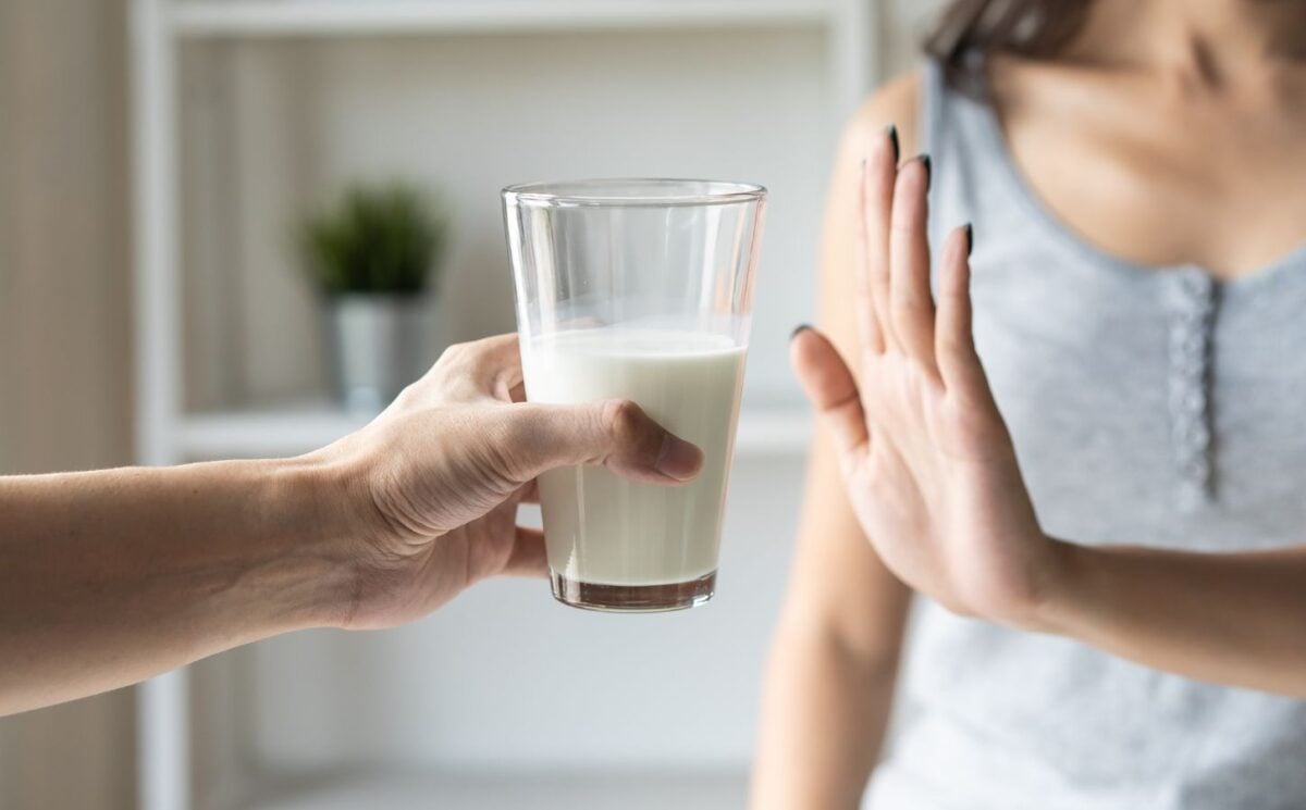 A person putting her hand up to reject a glass of dairy milk, which is linked to reduced risk of bowel cancer