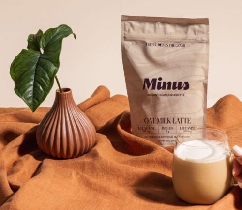 Photo shows the new Minus Instant Vanilla Oat Milk Latte in its packaging and made into a cup of coffee